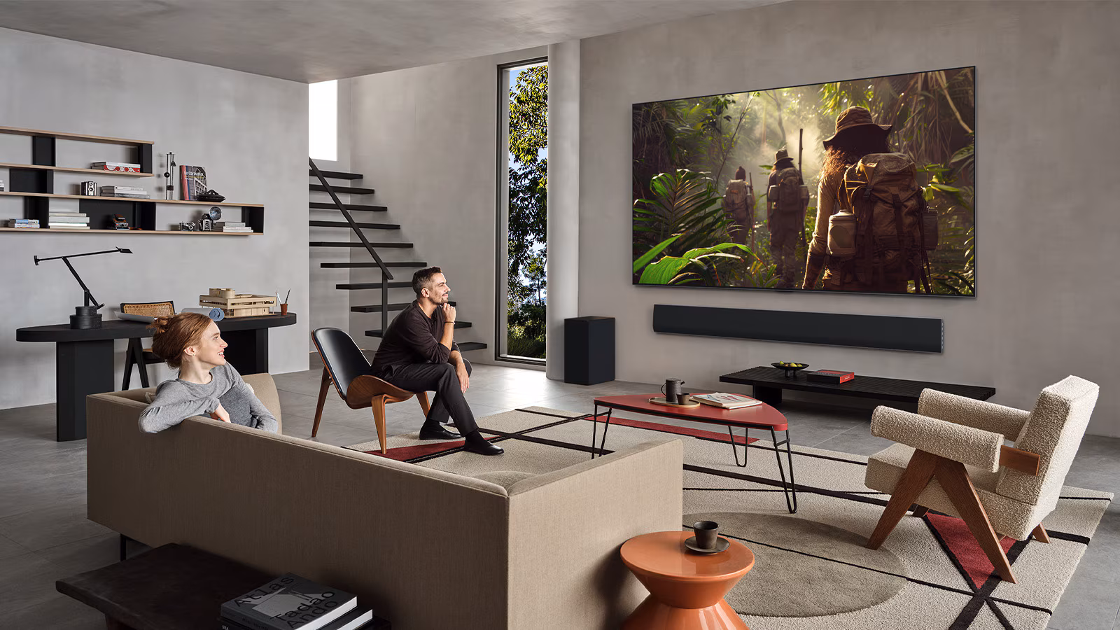 An image showing a couple watching an LG G5 OLED TV in a modern living room.
